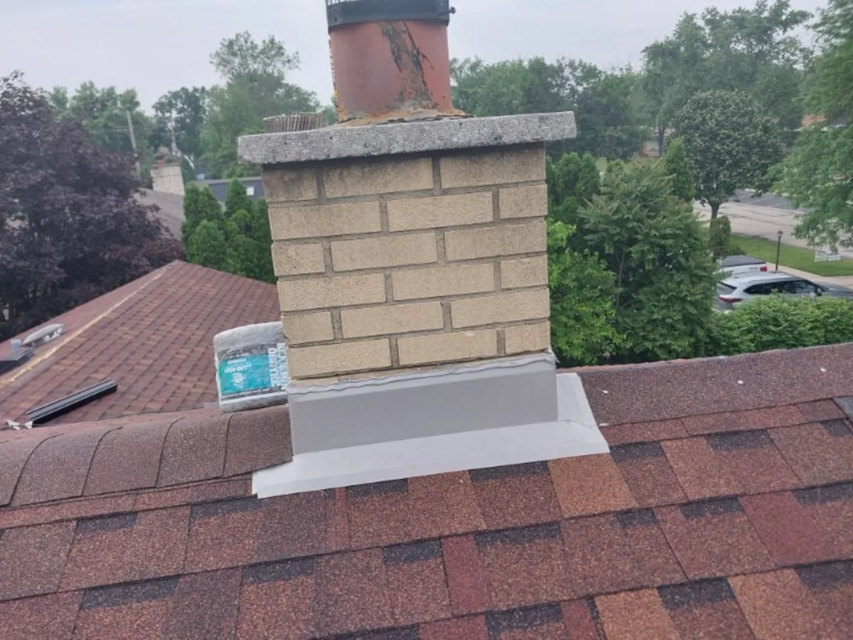 New flashing around a brick chimney on a shingle roof