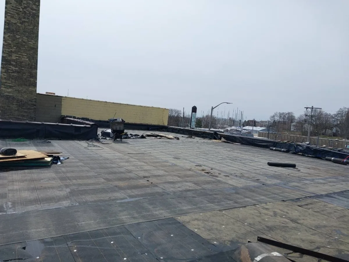 Flat roof membrane being installed on a commercial building