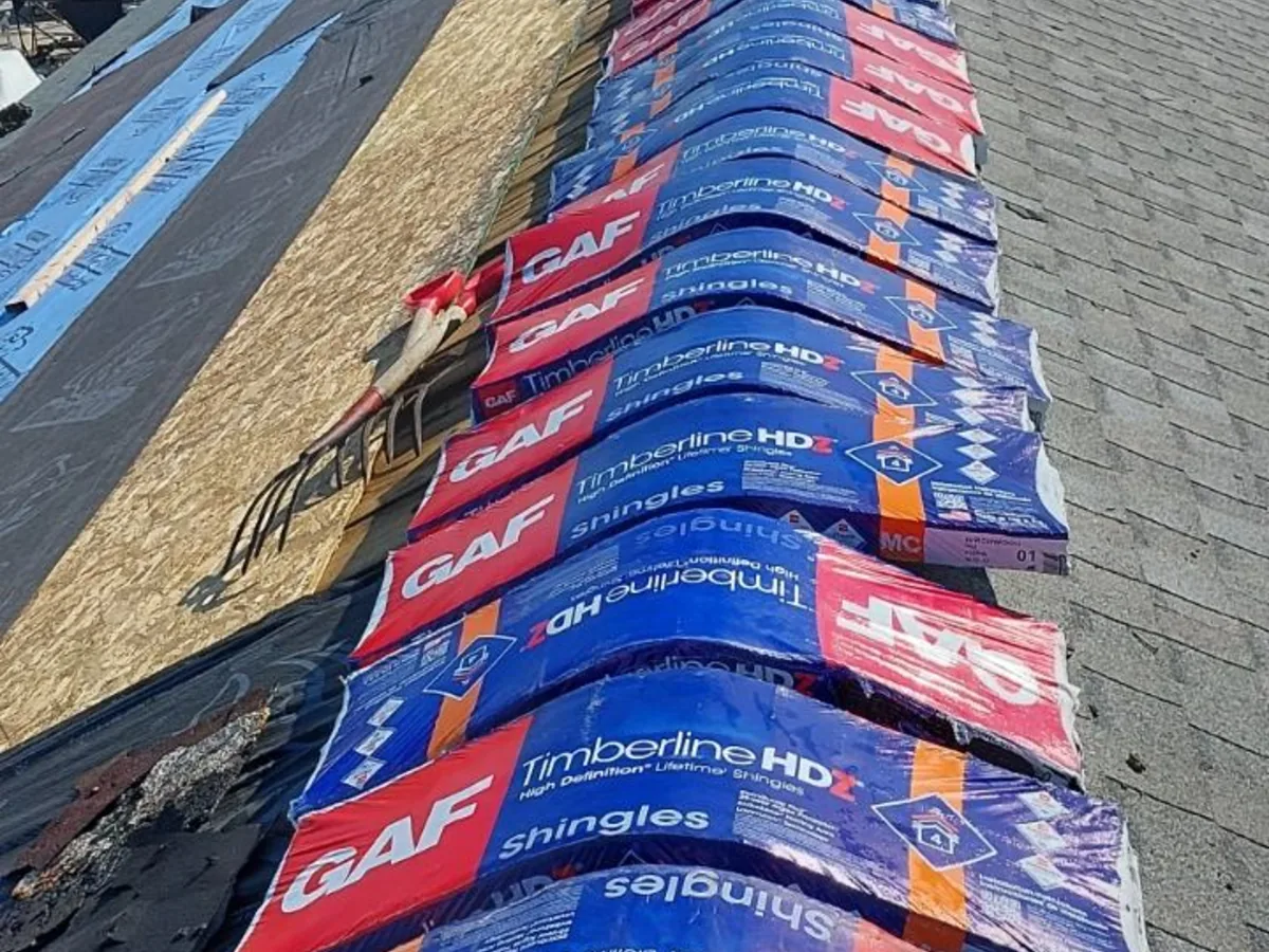 GAF Timberline HDZ shingle bundles stacked on a roof deck