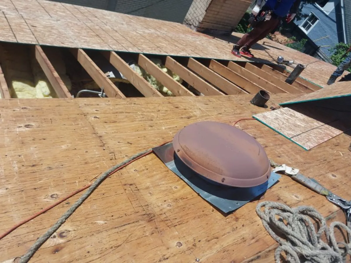 New plywood roof decking with a vent boot installed