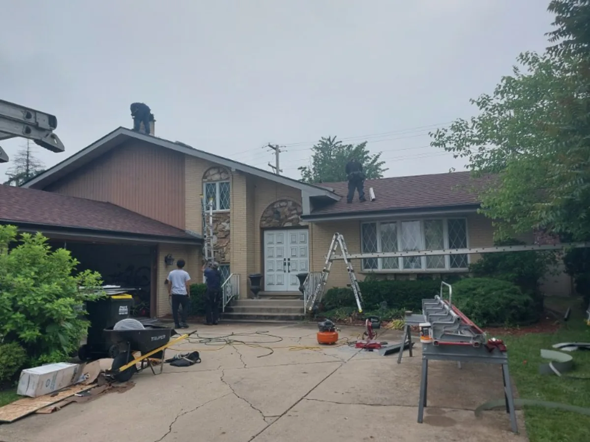 Roofing crew working on a home roof replacement
