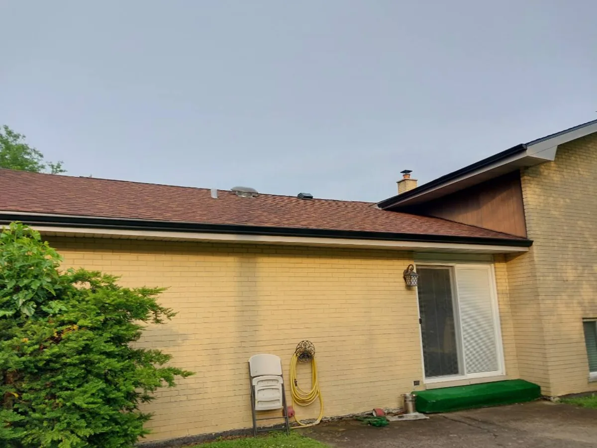 Asphalt shingle roof on a yellow brick ranch home