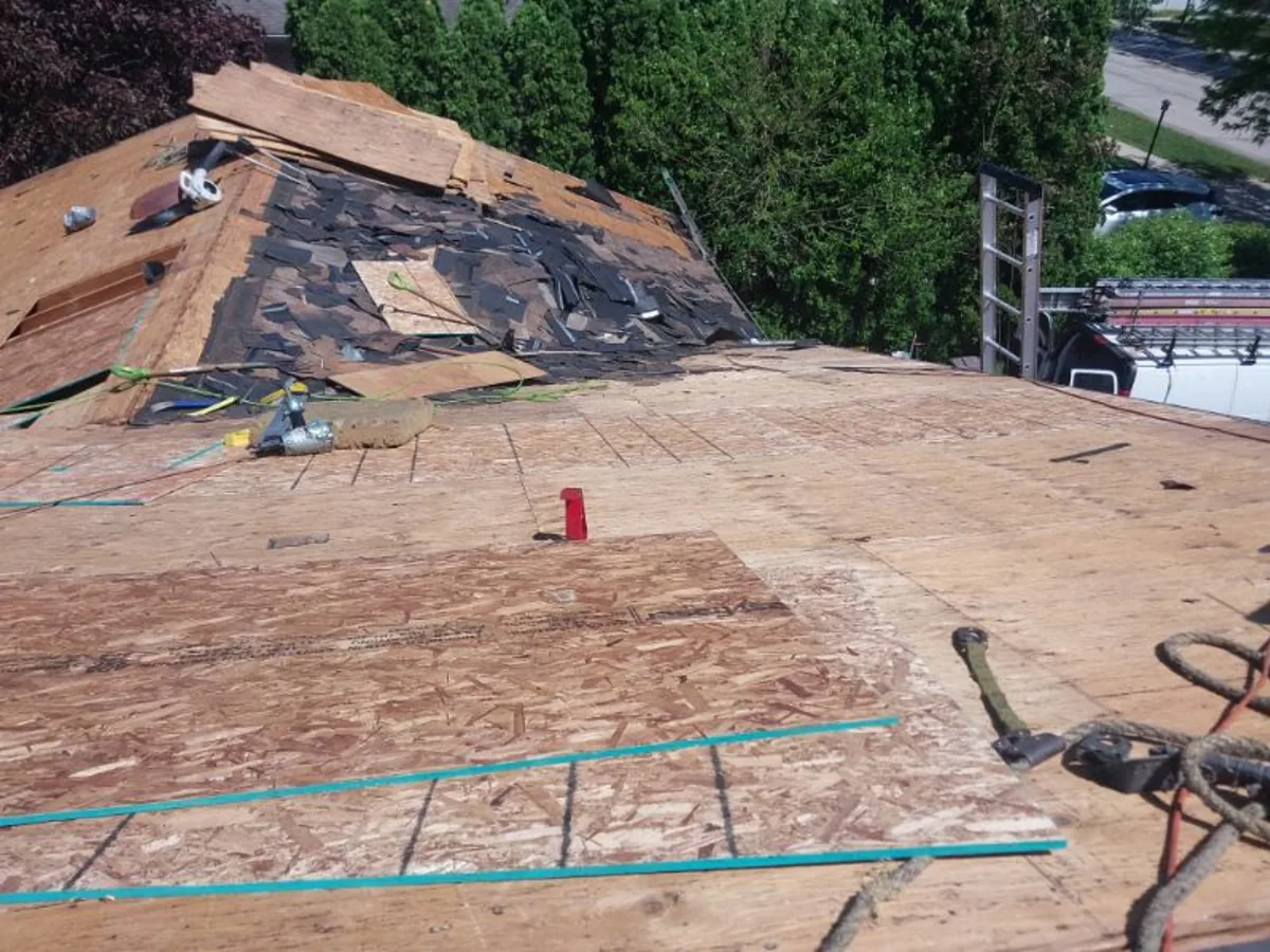 Shingle tear off exposing wood decking on a home roof